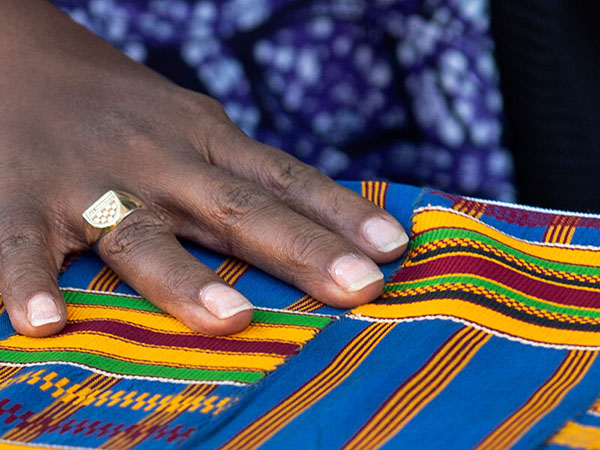 Black hand on African cloth